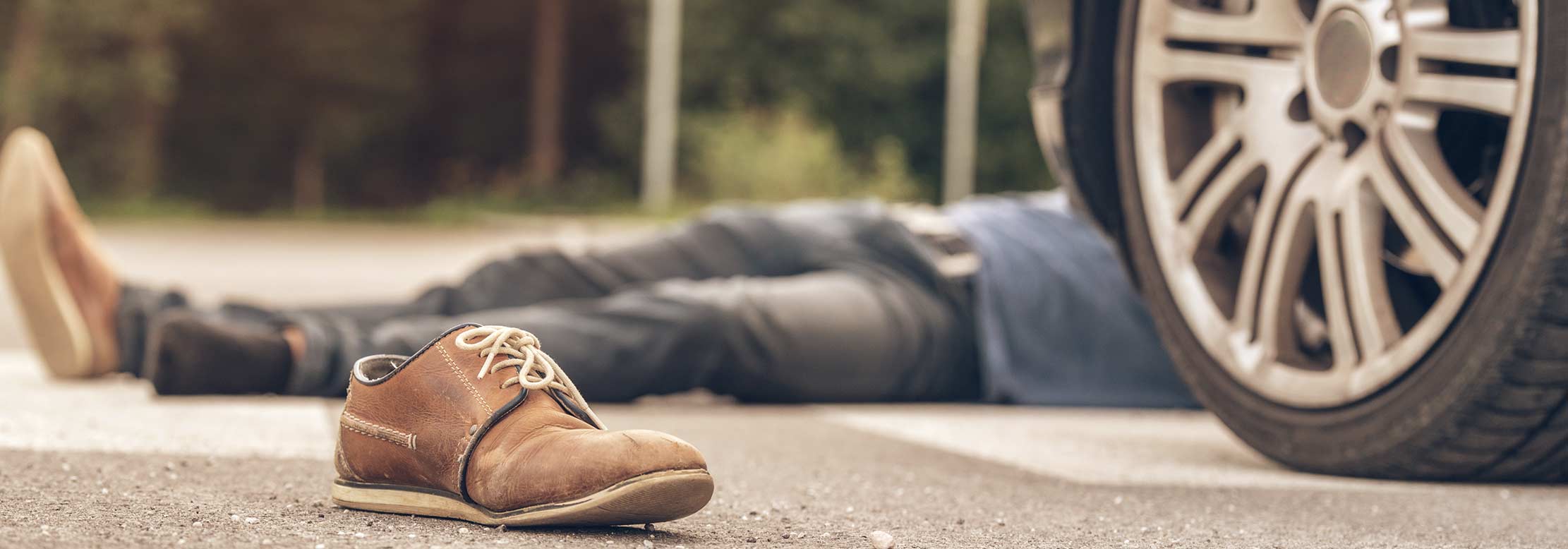 Pedestrian lies unconscious after being hit by a car.
