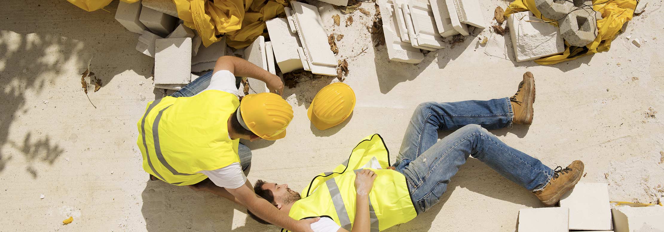 Construction worker lies on ground after getting hurt.