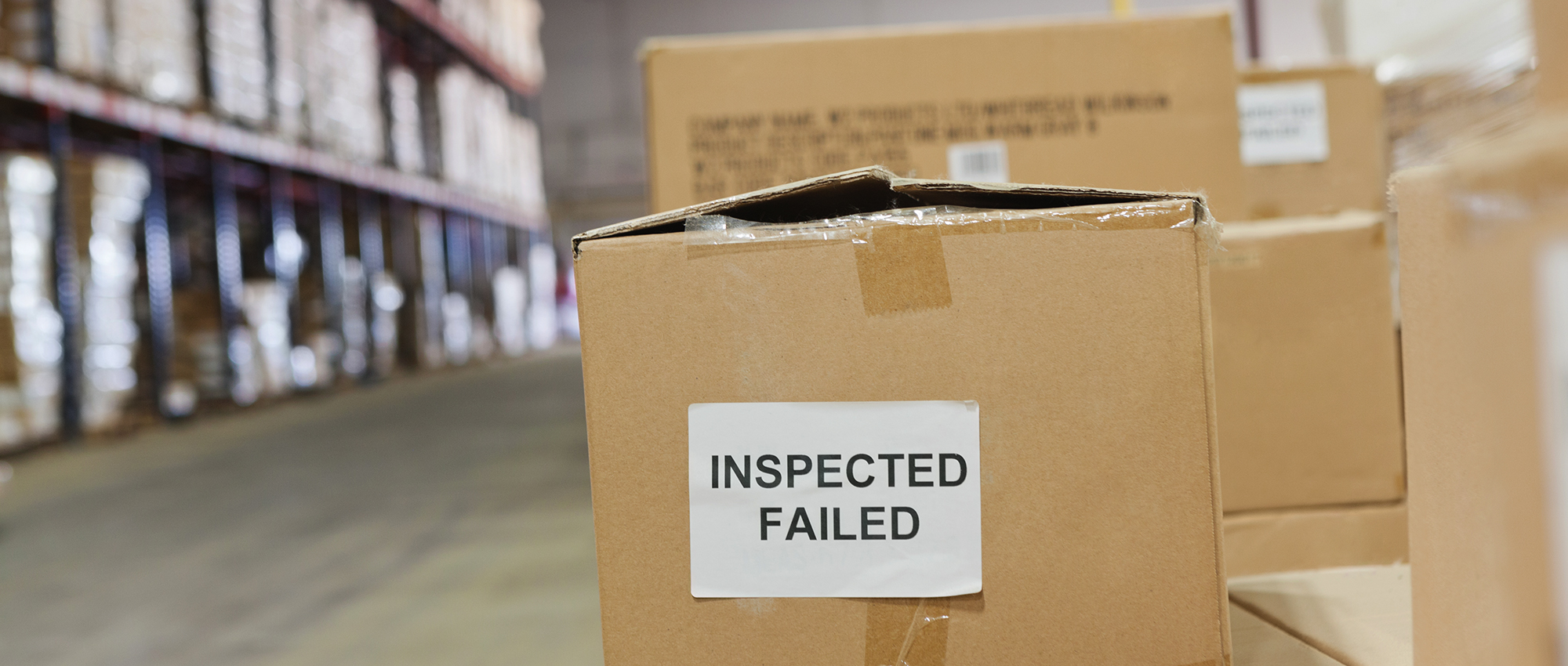Inspected and failed boxed products are lined up on warehouse.