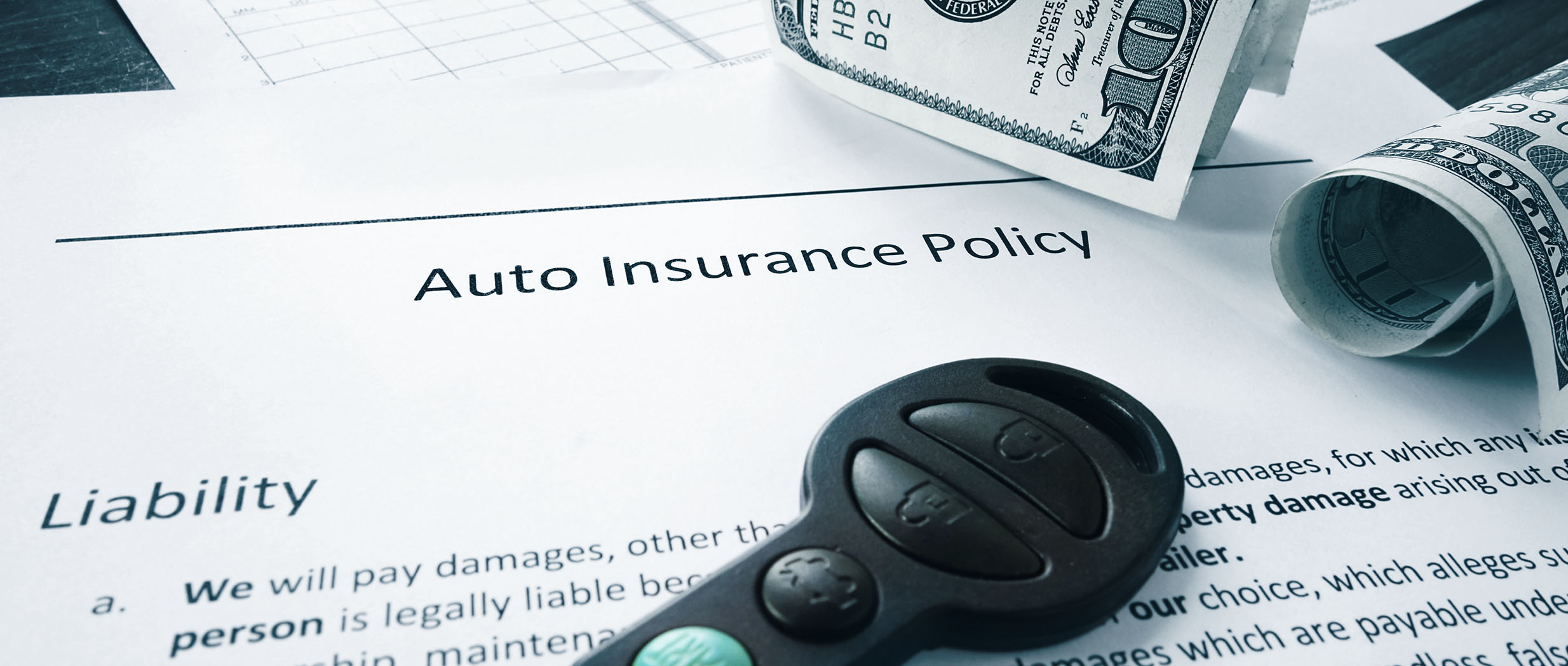 Auto Insurance Policy lays on desk.