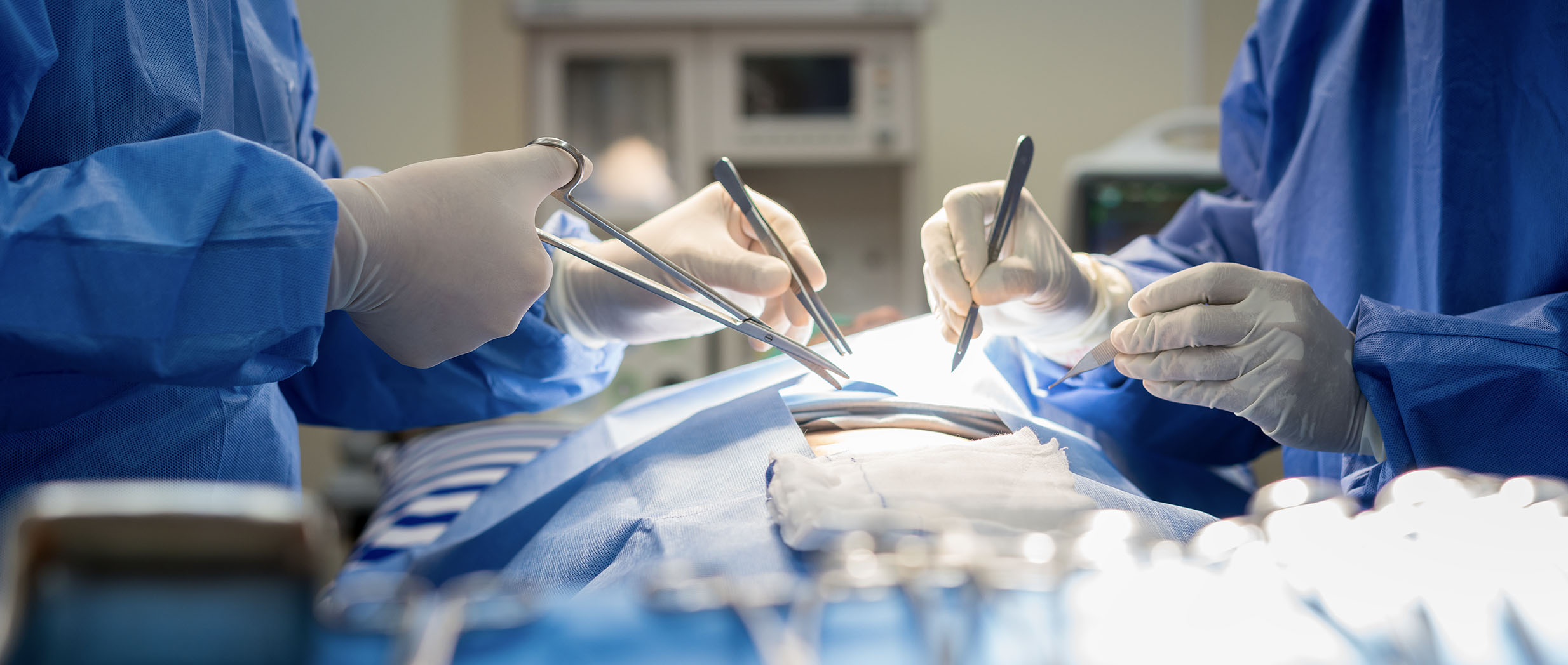 Doctor performs surgery on patient in operating room.