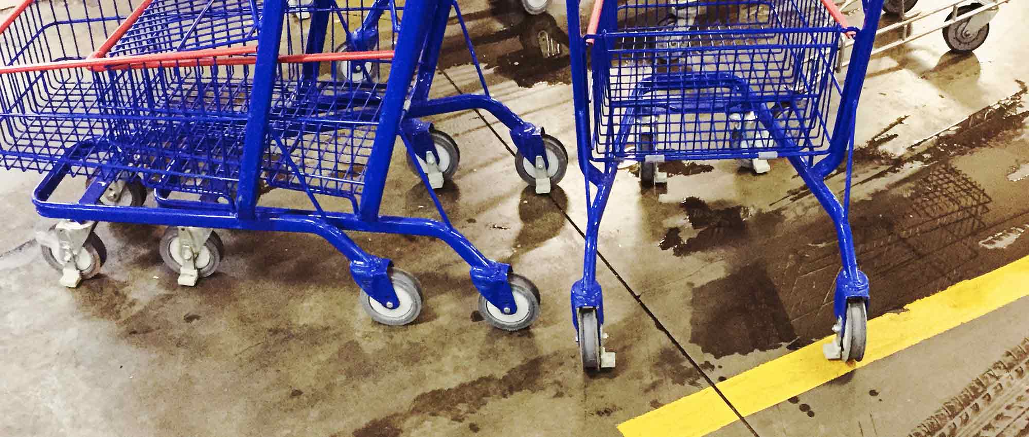 Supermarket floor is wet in the carts area.