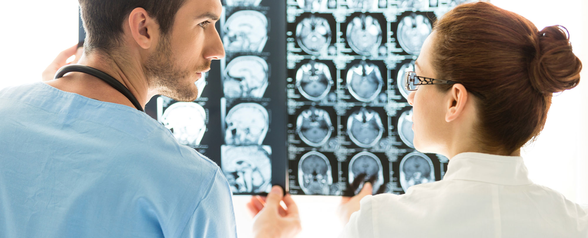 physicians looking at brain scan images