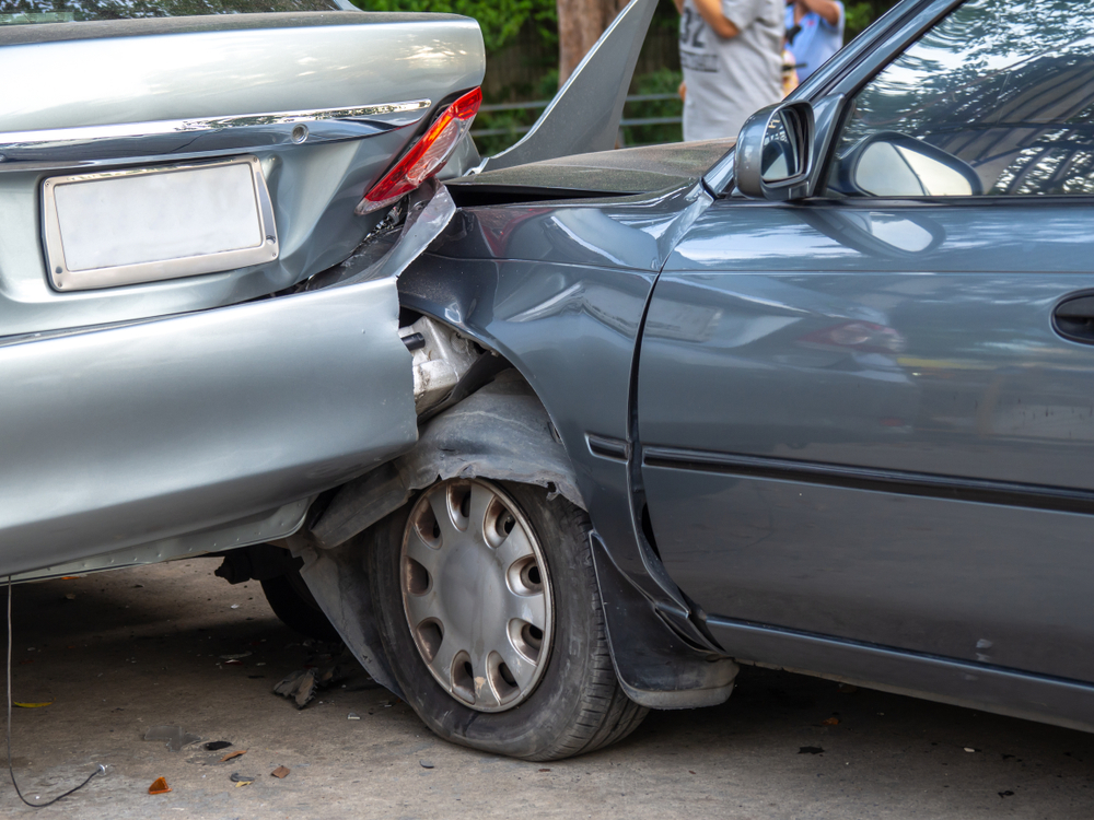 Car crash on the street with wrecked and damaged vehicles. Accident caused by negligence and lack of driving ability due to illness.