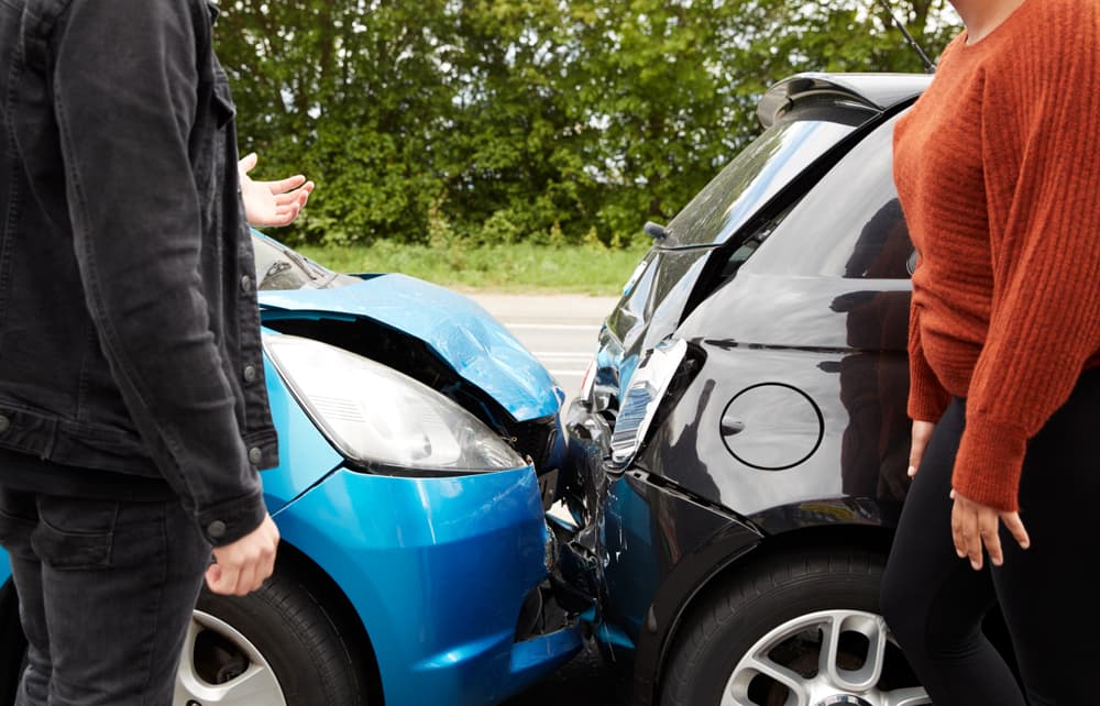 Two frustrated drivers arguing over who is at fault for a car accident.