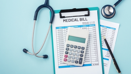 medical bill, stethoscope, and calculator, representing the hidden costs of an accident injury claim