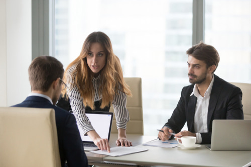 a group of professionals reviewing documents, representing the process of uncovering hidden assets in an accident injury claim settlement