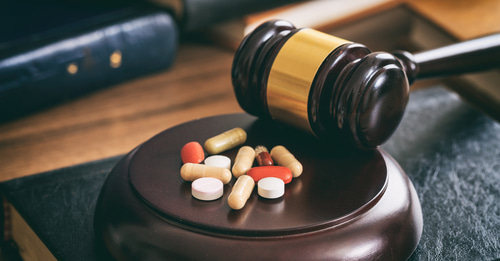 a gavel and pills, symbolizing the legal and medical complexities in wrongful death claims, and how a lawyer can help navigate issues like medical negligence or malpractice