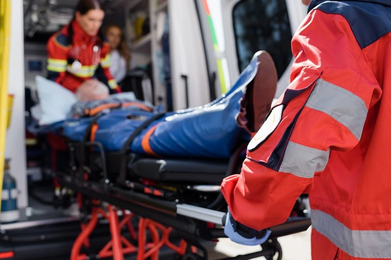 An accident victim getting loaded into the back of an ambulance.