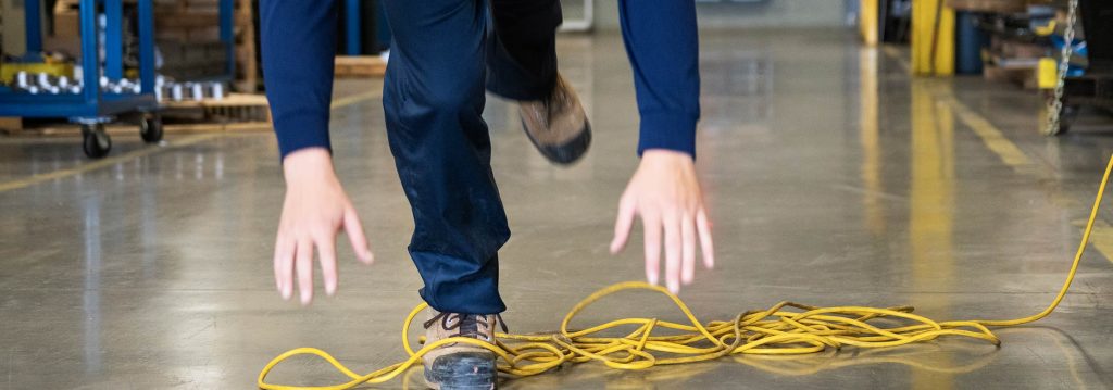 Person falling at work in a warehouse with concrete floors