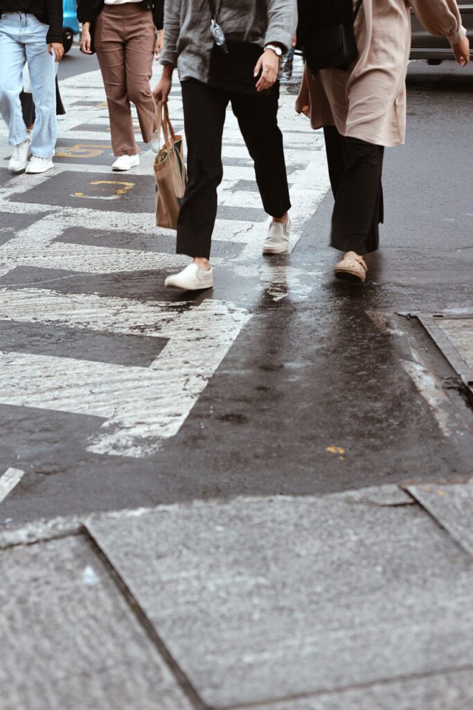 Pedestrians in a crosswalk crossing the street 