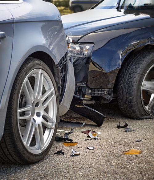 The two luxury cars collide in an accident, scattered broken pieces on the ground